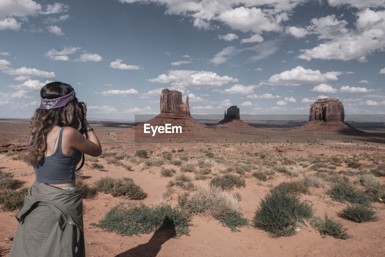 Panoramic view of woman on desert against sky. shooting