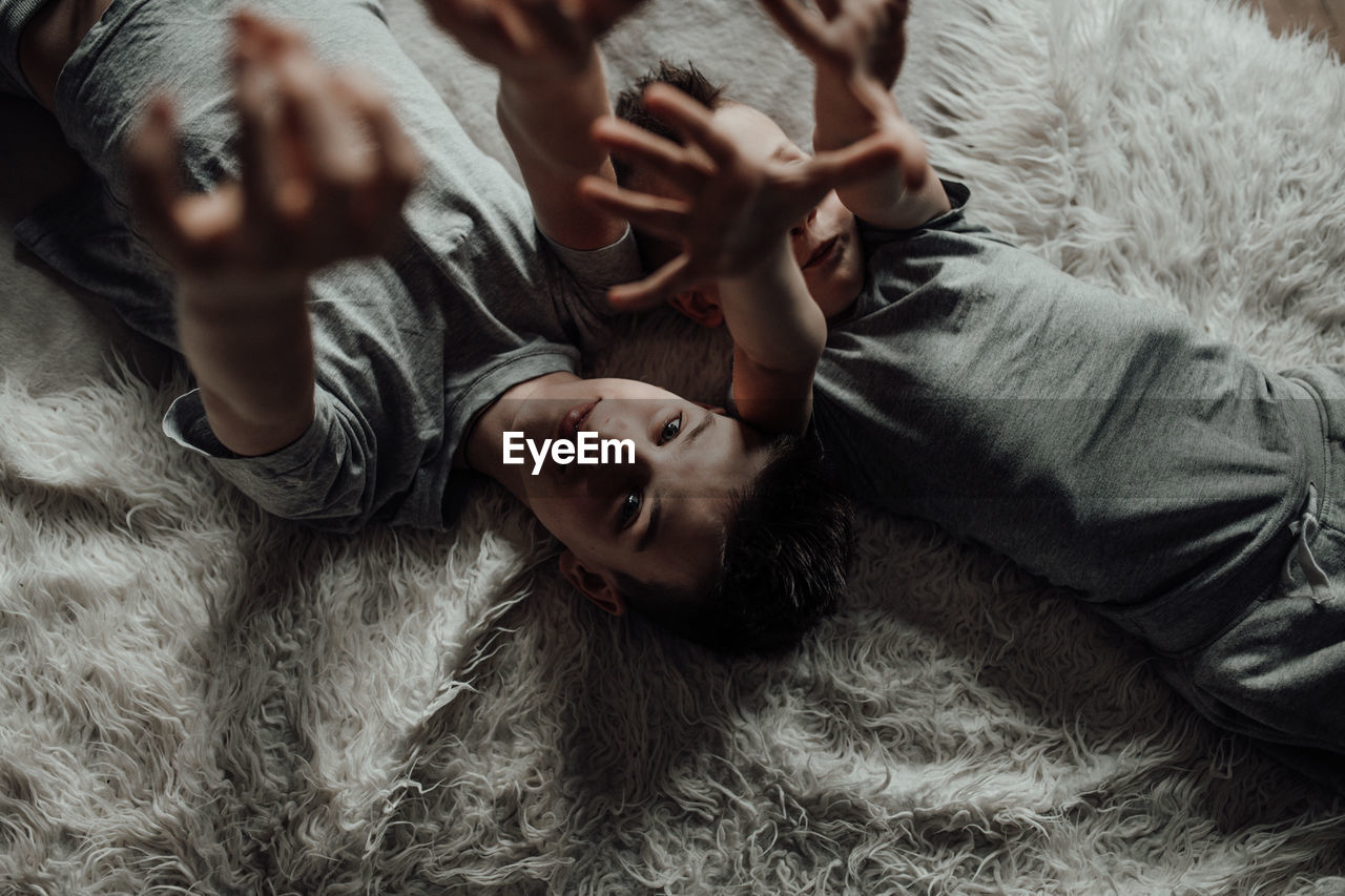 High angle view of baby lying on bed