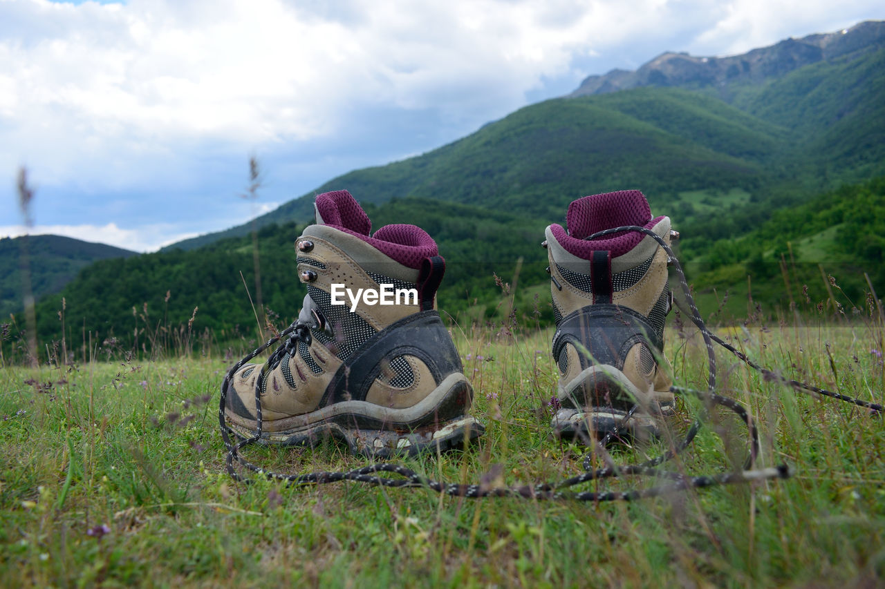 Hooded chairs on field against sky