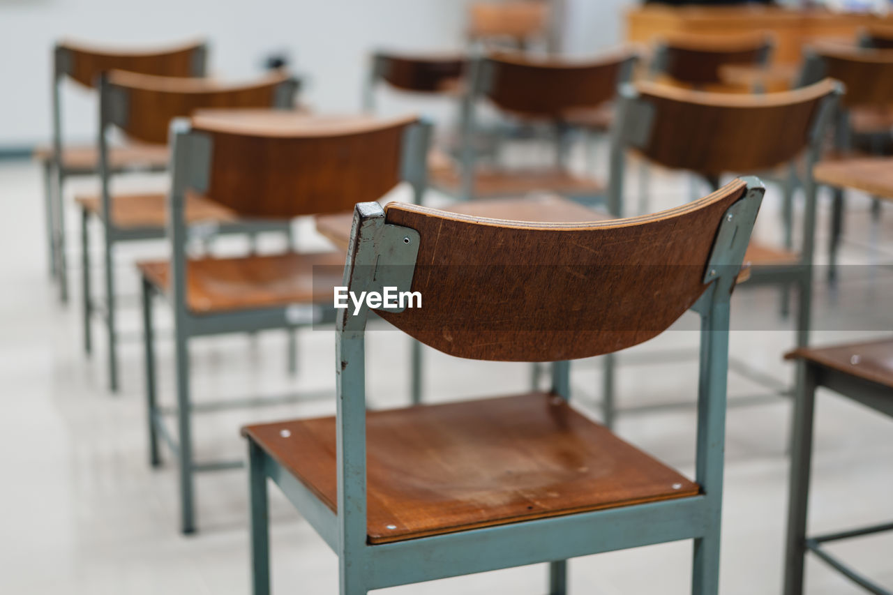 CLOSE-UP OF EMPTY CHAIRS IN RESTAURANT