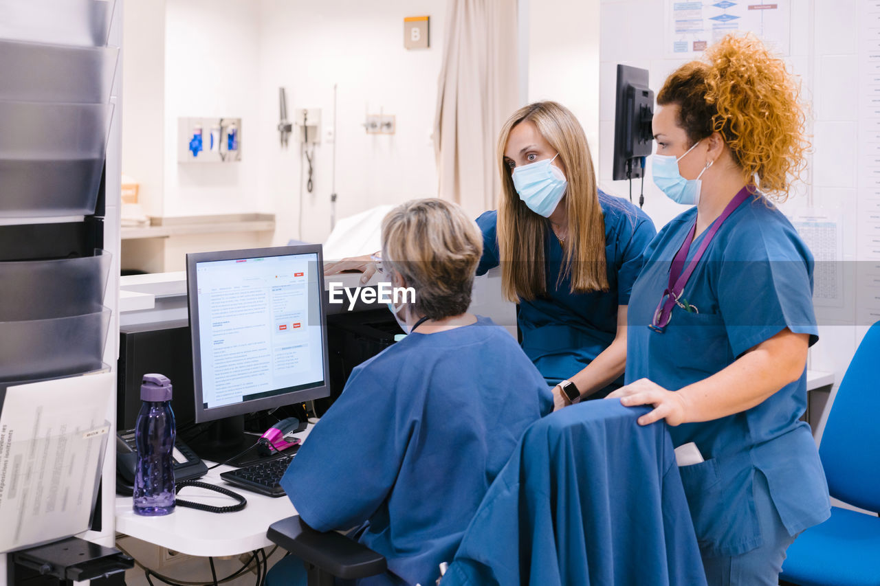 Nurses wearing protective face mask having discussion at hospital