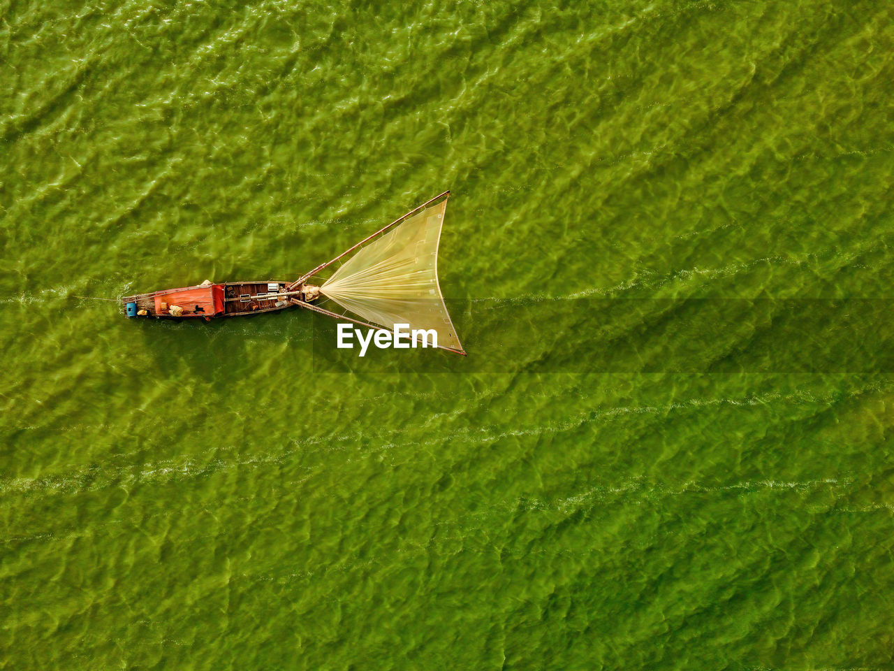 Aerial view of fishing boat moored at harbor