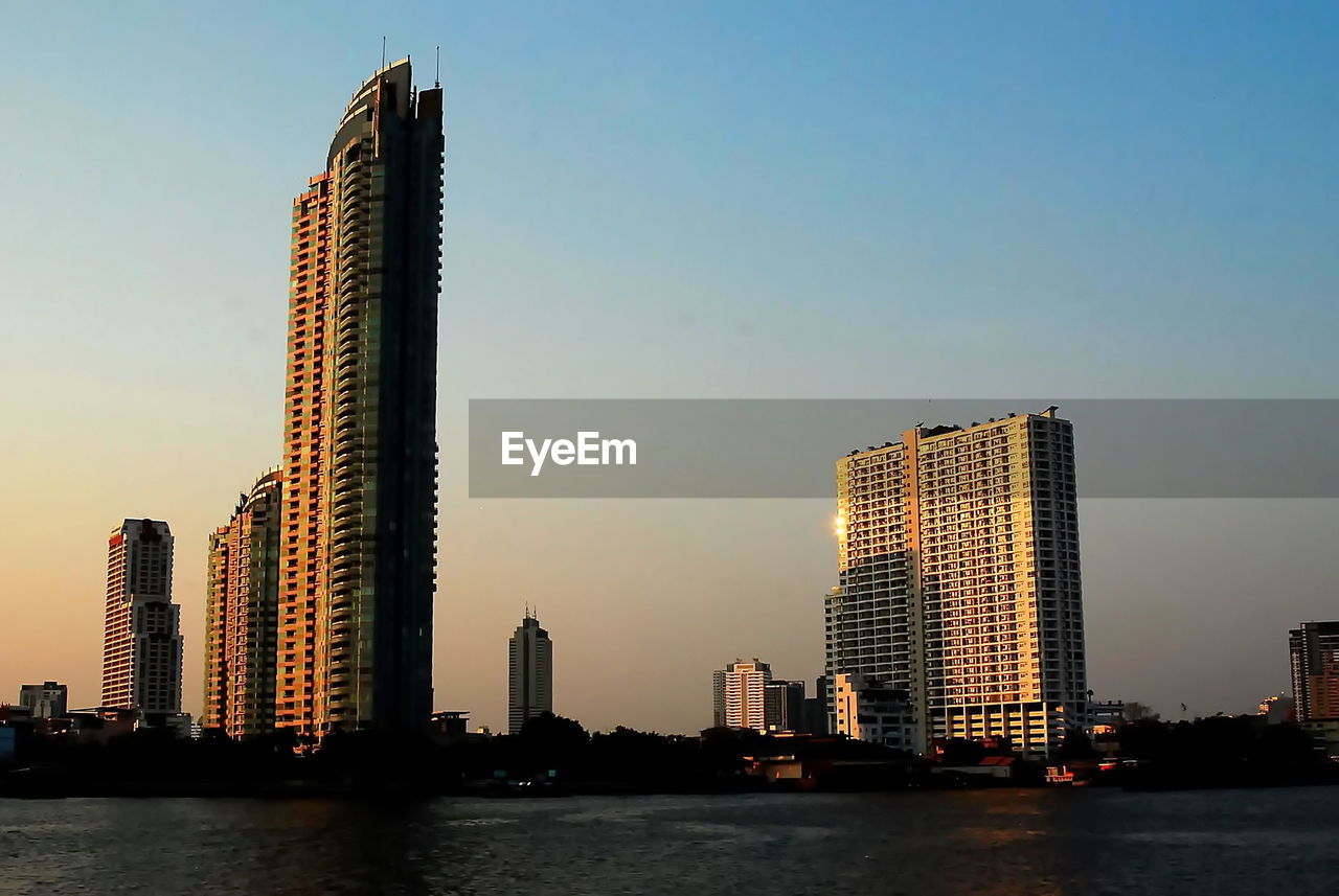 SKYSCRAPERS BY RIVER AGAINST SKY