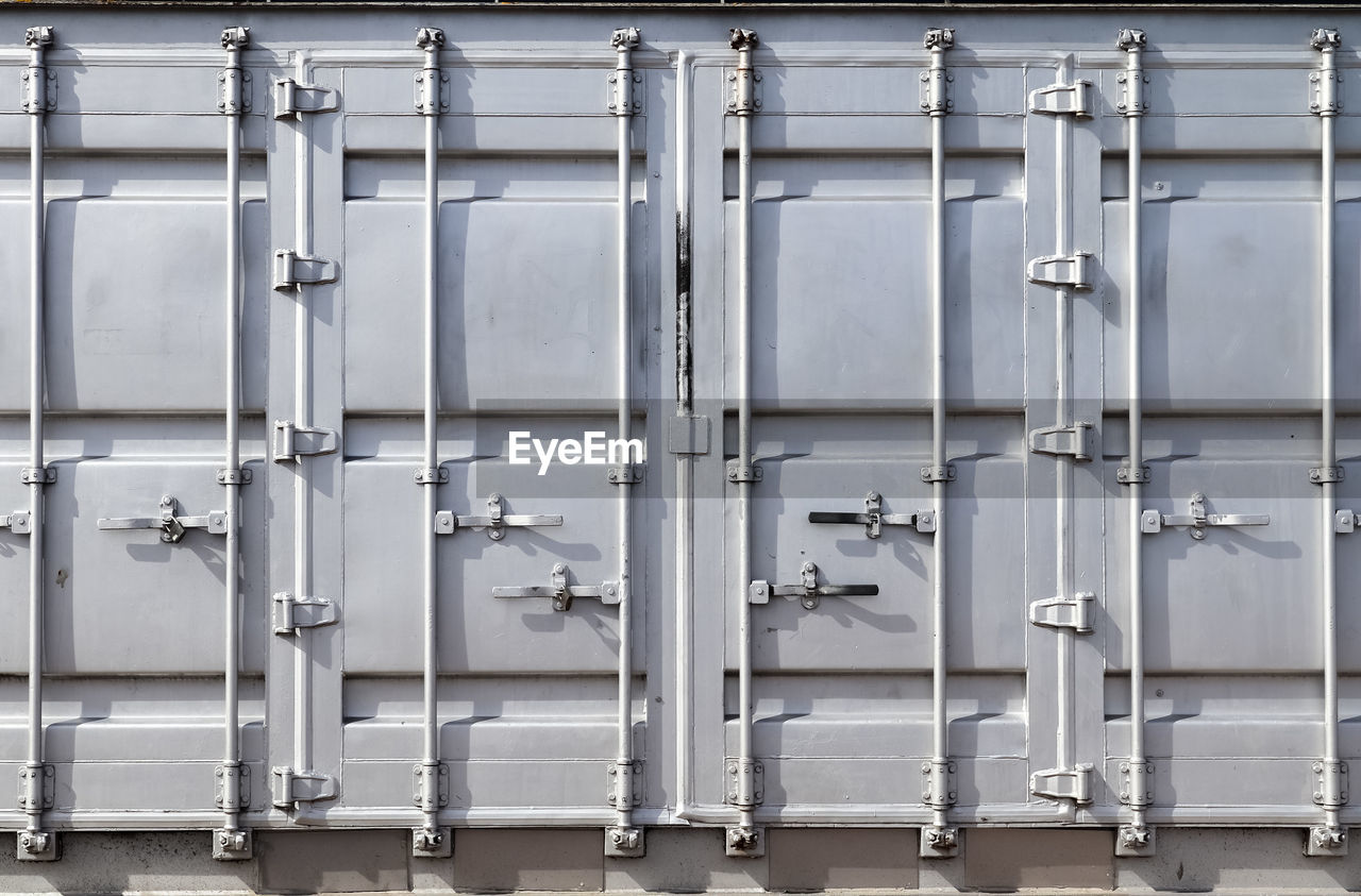 Detailed close up view on metal and steel surfaces on a silver cargo containter