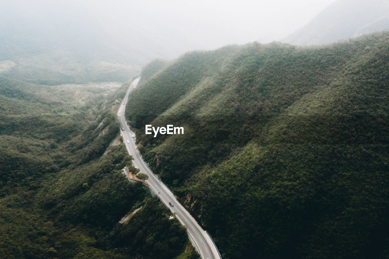 HIGH ANGLE VIEW OF ROAD AMIDST MOUNTAINS