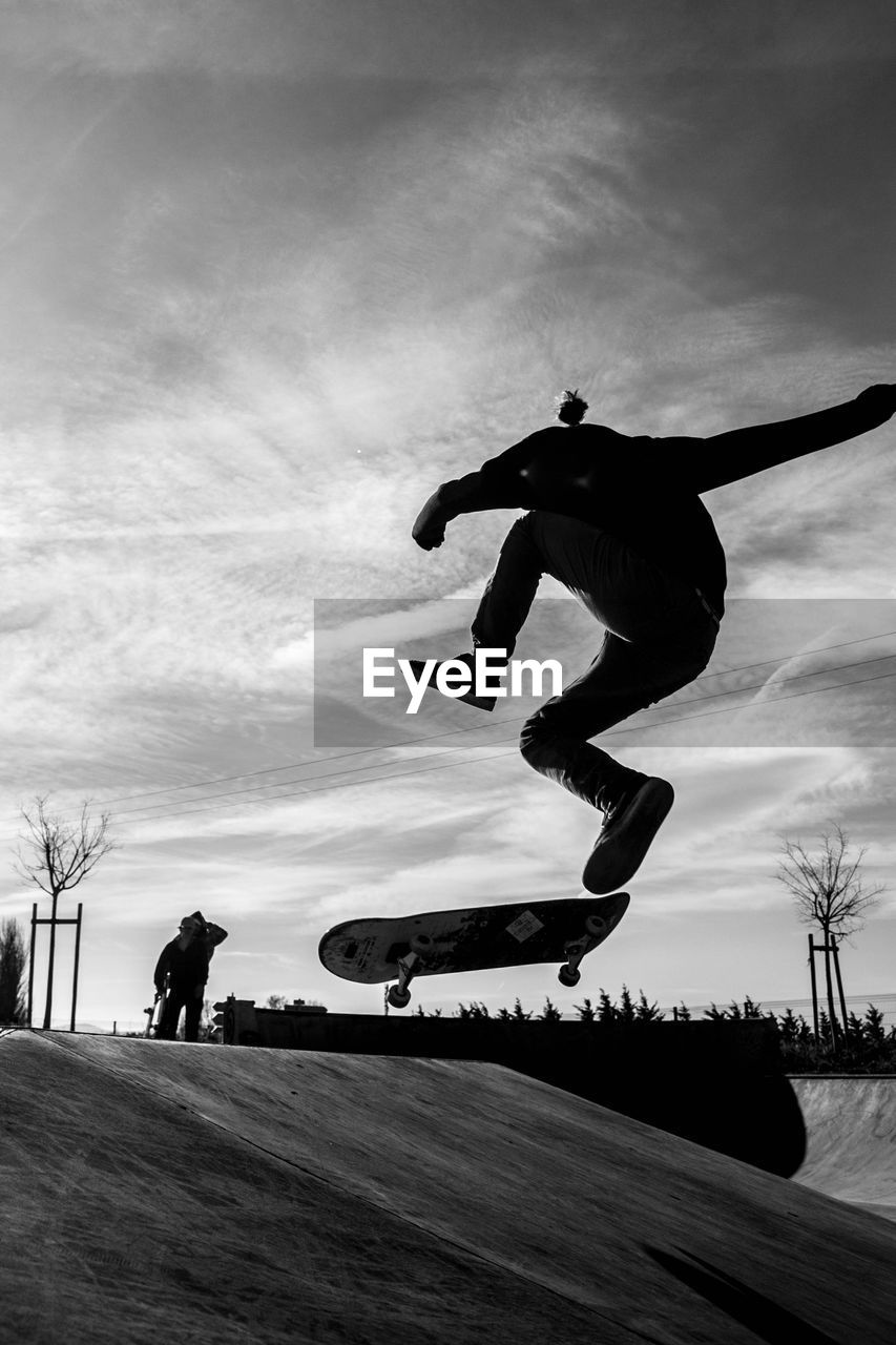 MAN JUMPING ON SKATEBOARD