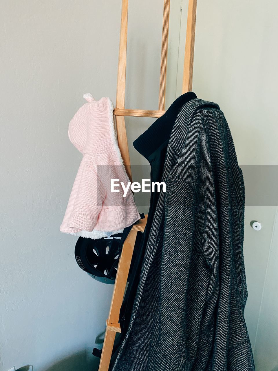 CLOSE-UP OF CLOTHES DRYING ON WALL AT HOME