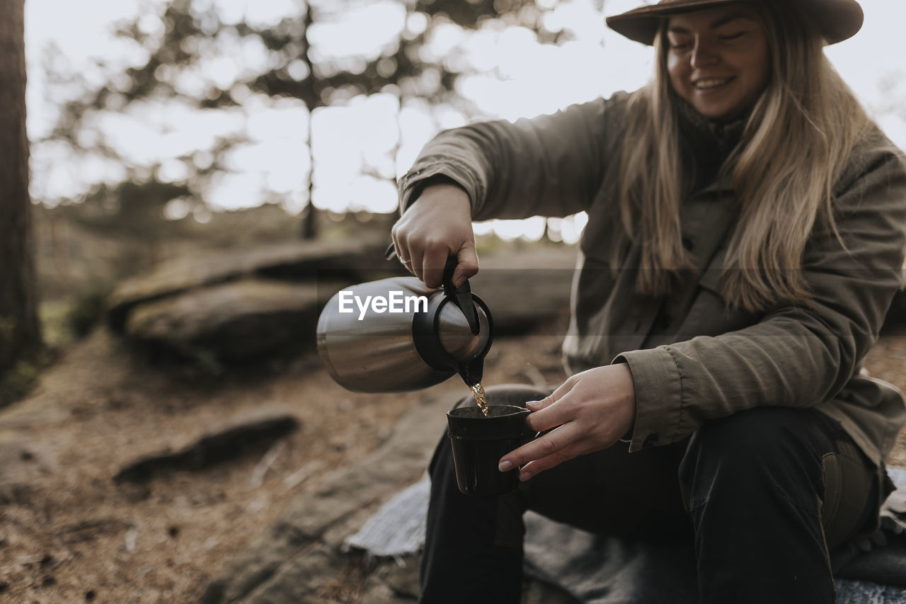 Smiling woman having coffee break