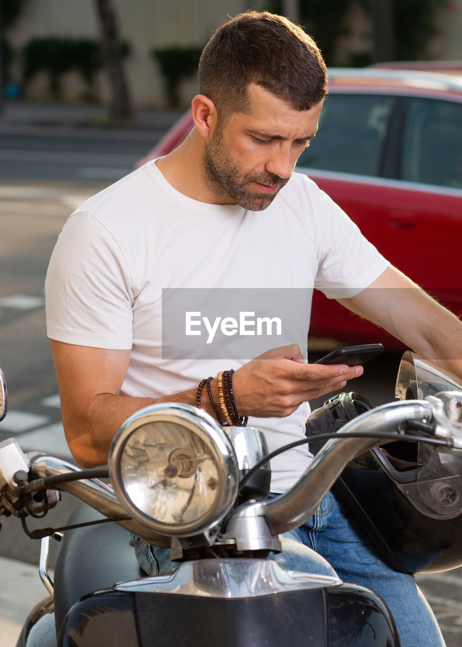 MID ADULT MAN HOLDING CAR