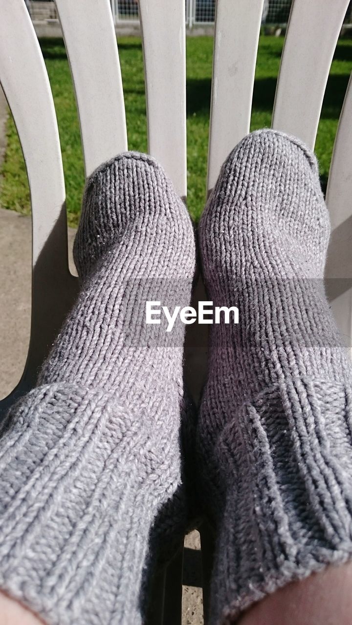 Persons legs wearing woolen socks