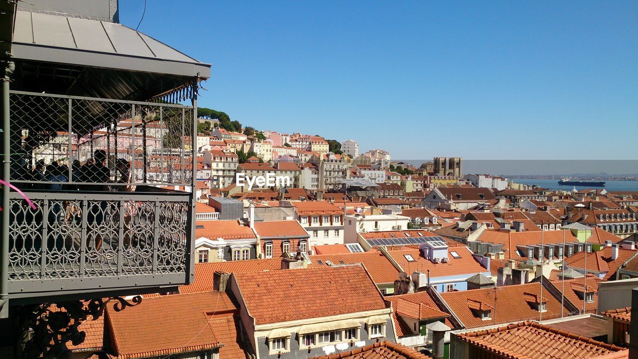 BUILDINGS IN TOWN AGAINST CLEAR BLUE SKY