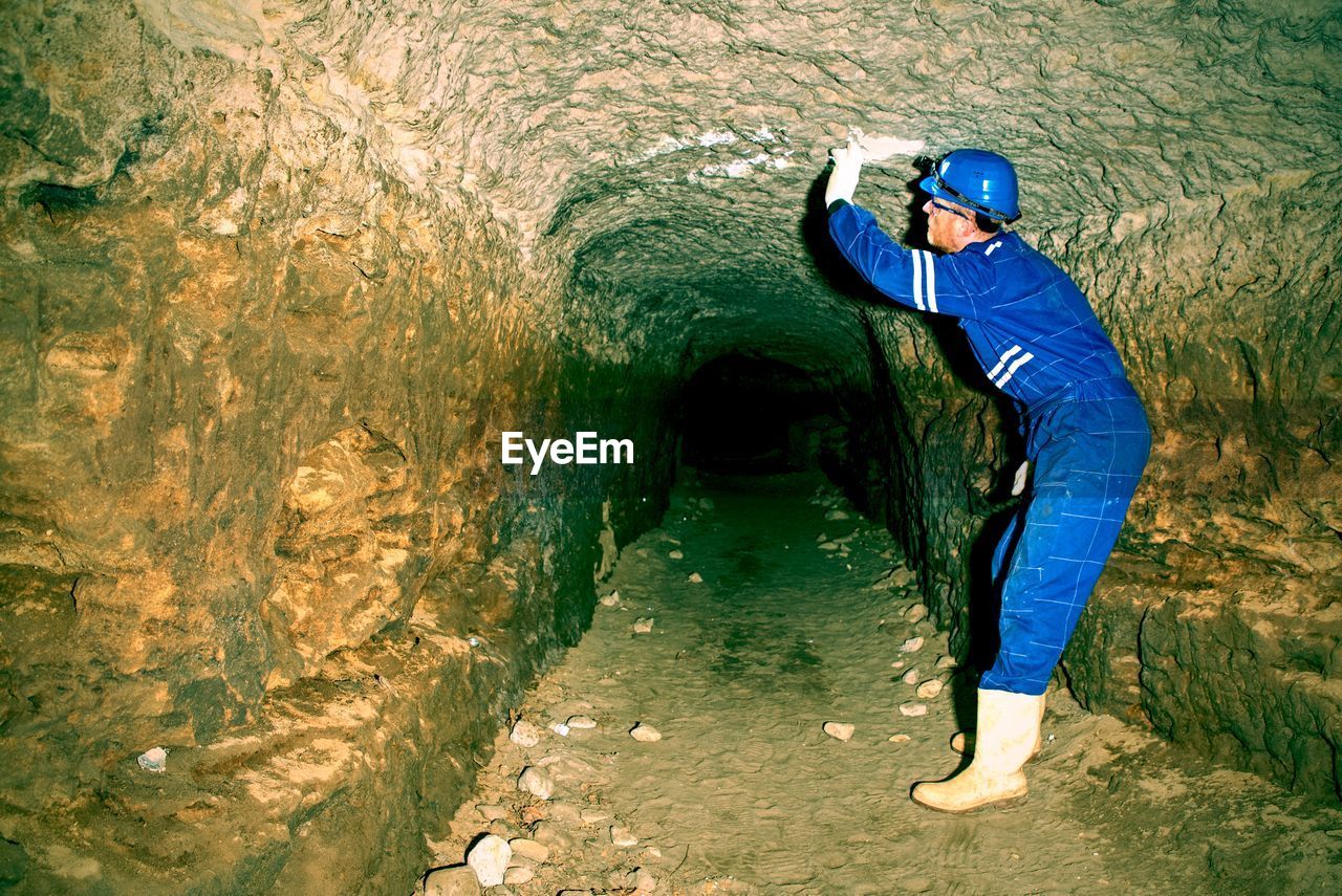 Entrance to the underground passages built by man for defense. background of the tunnel with stone