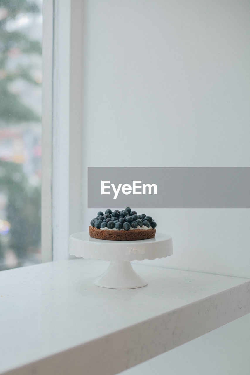 Blueberry cake on window sill