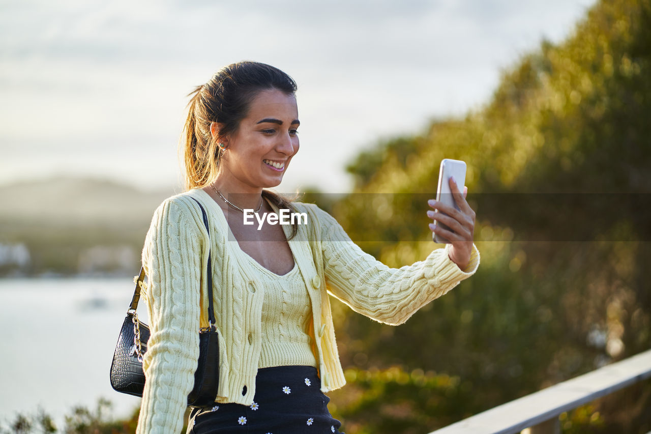 Young woman using mobile phone outdoors