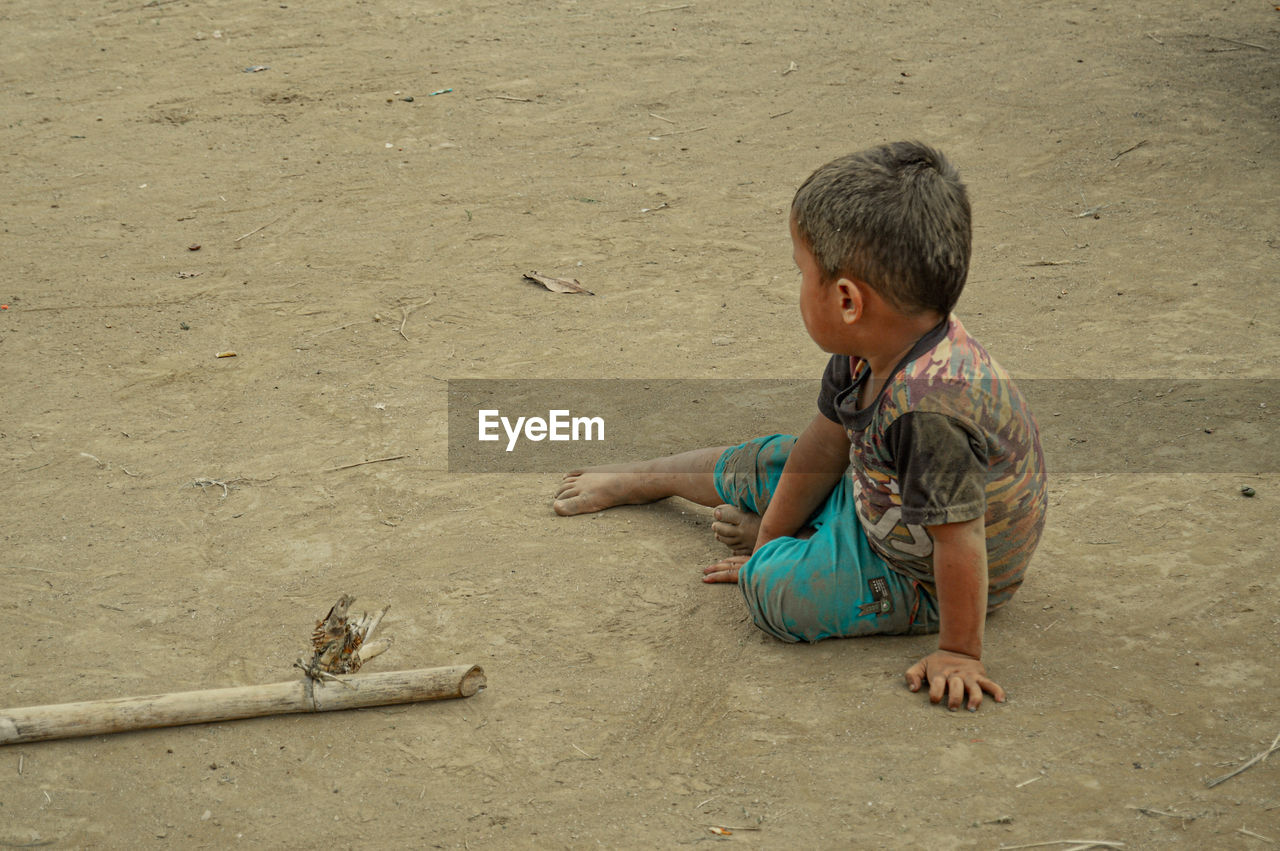 childhood, child, sand, men, land, one person, beach, person, full length, high angle view, sitting, toddler, nature, temple, day, poverty, casual clothing, outdoors, animal, lifestyles, baby, animal themes, leisure activity, innocence, looking, cute