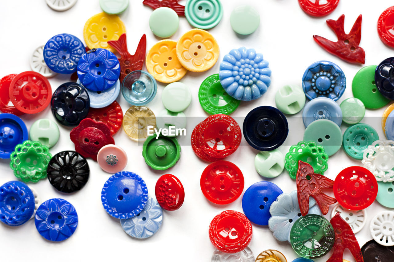 Full frame shot of colorful buttons on white background