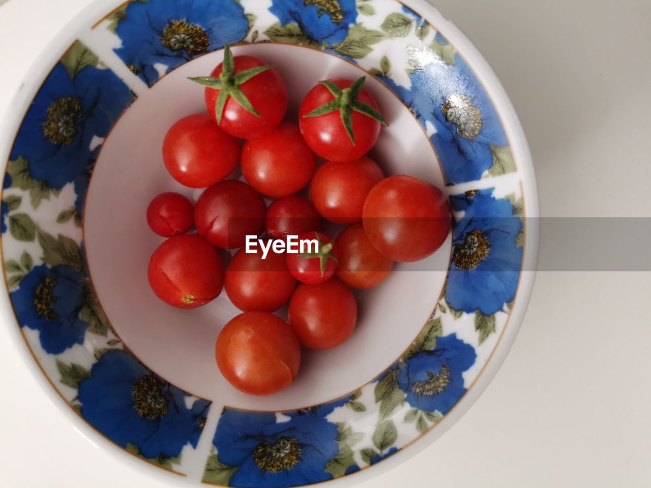 food, food and drink, healthy eating, plate, fruit, red, tomato, produce, wellbeing, vegetable, plant, freshness, directly above, no people, blue, indoors, bowl, close-up, nature, geometric shape, still life, circle, shape