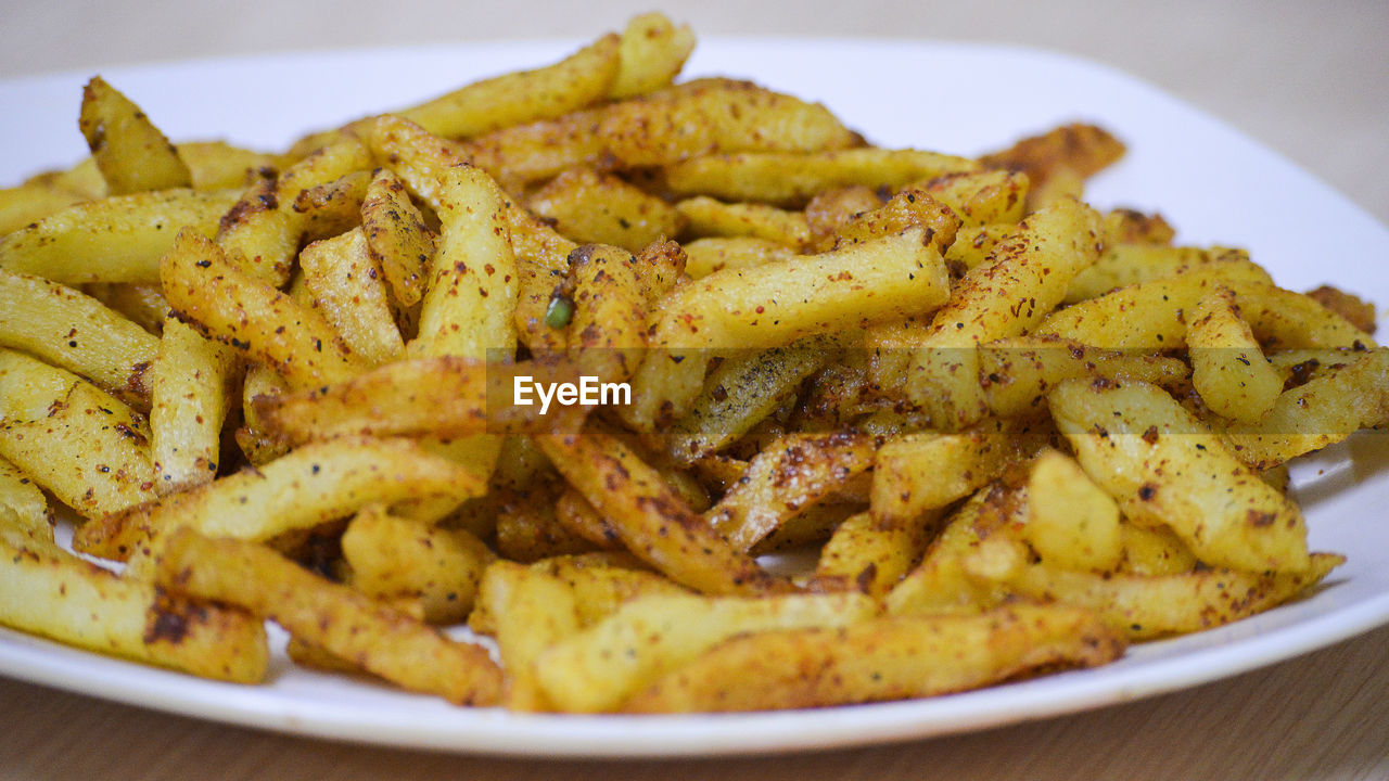 Close-up of french fries in plate on table