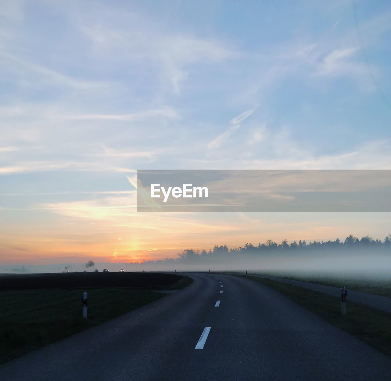 ROAD AMIDST LANDSCAPE AGAINST SKY DURING SUNSET