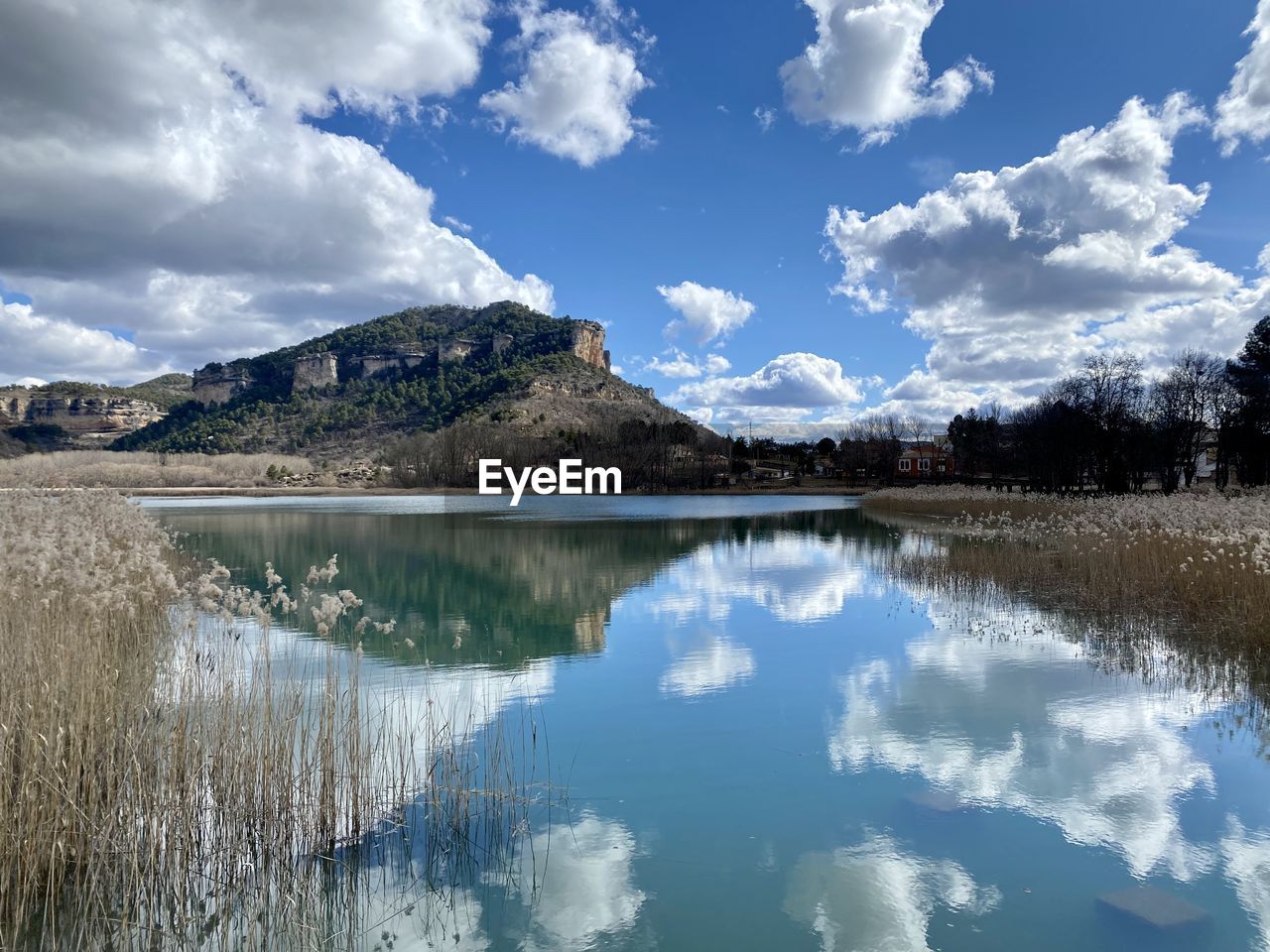 reflection, water, sky, nature, scenics - nature, cloud, mountain, lake, environment, beauty in nature, landscape, body of water, tranquility, tranquil scene, mountain range, no people, land, tree, reservoir, travel destinations, blue, plant, travel, non-urban scene, snow, outdoors, day, tourism, cold temperature, idyllic, wilderness, forest, winter