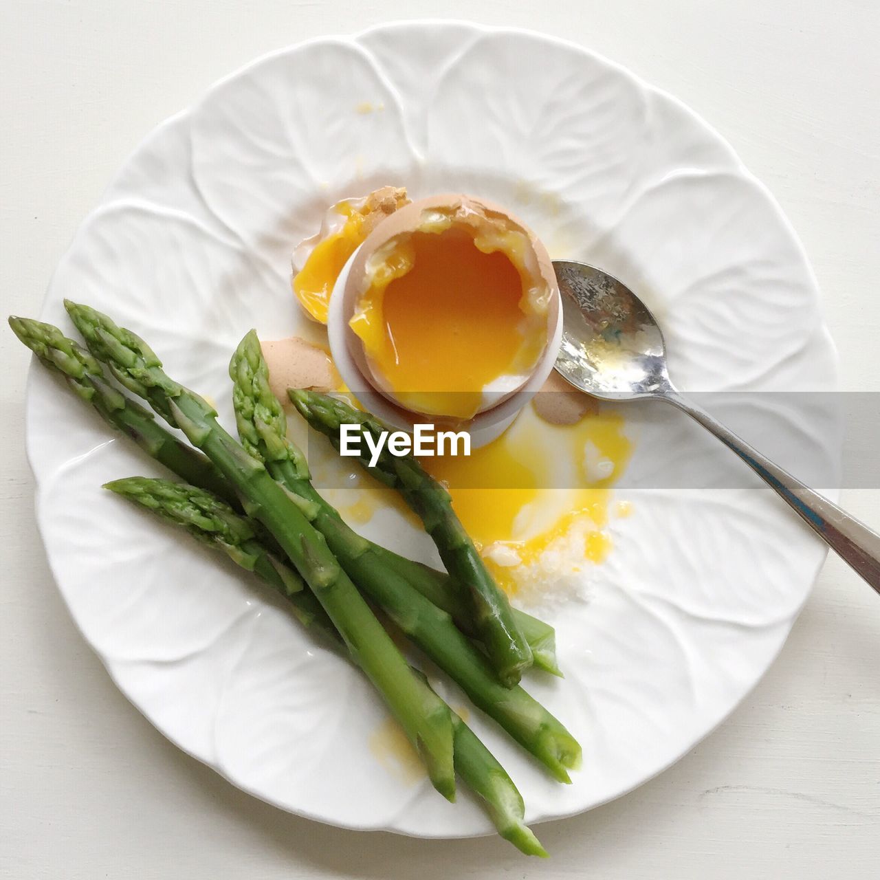 High angle view of asparagus and egg in plate on table