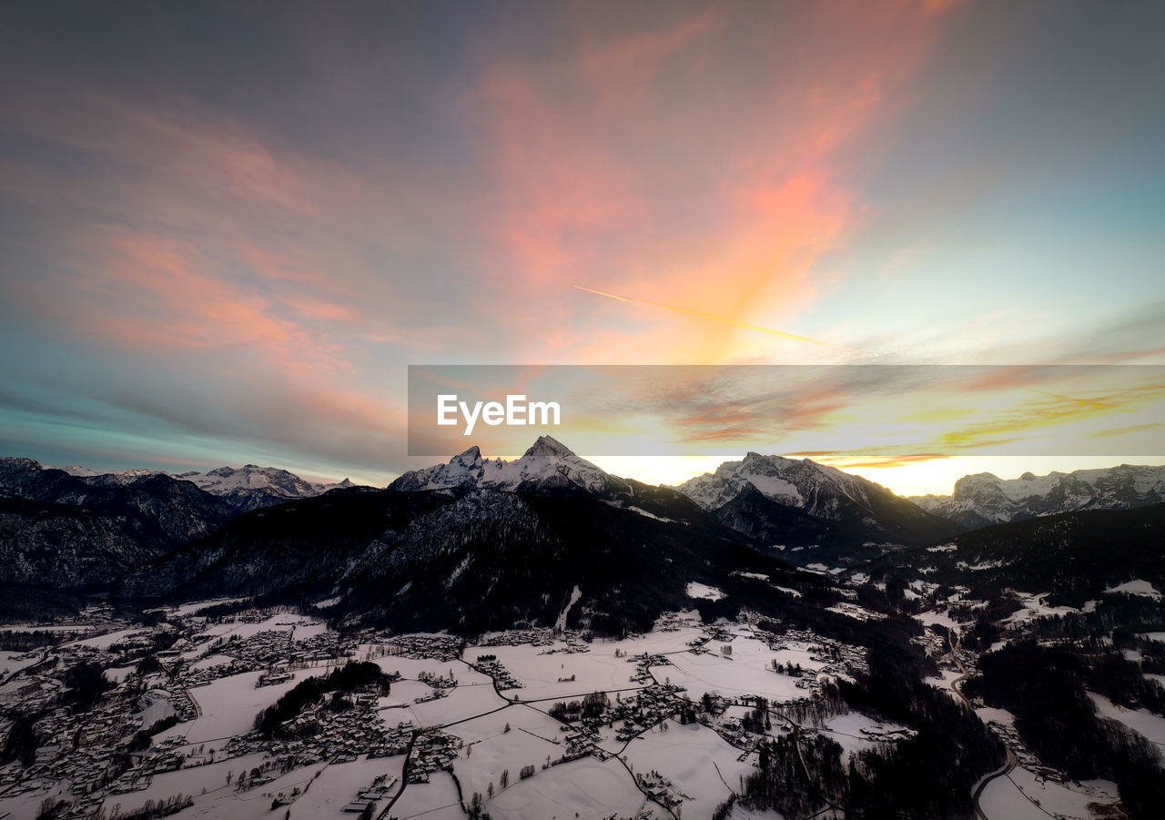 scenic view of snow covered mountains against sky during sunset