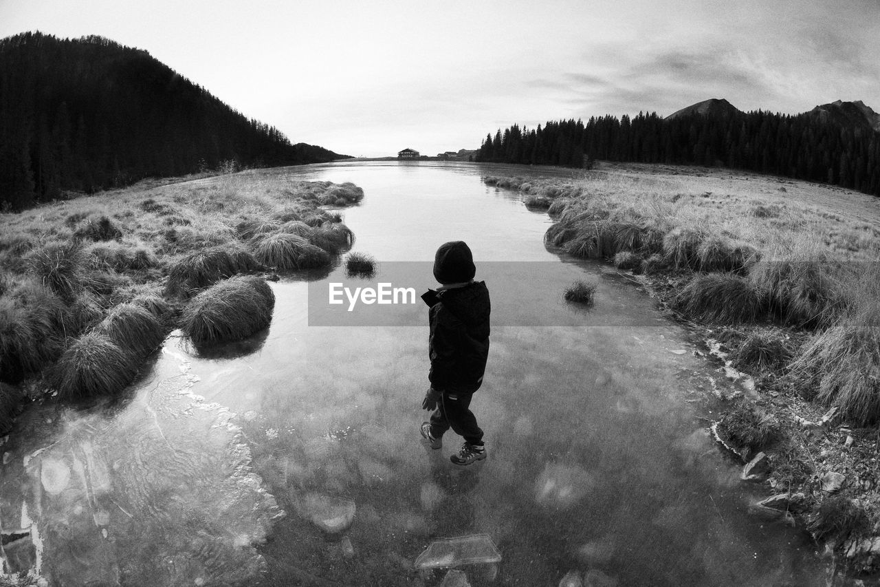 A boy walking in the nature of dolomites