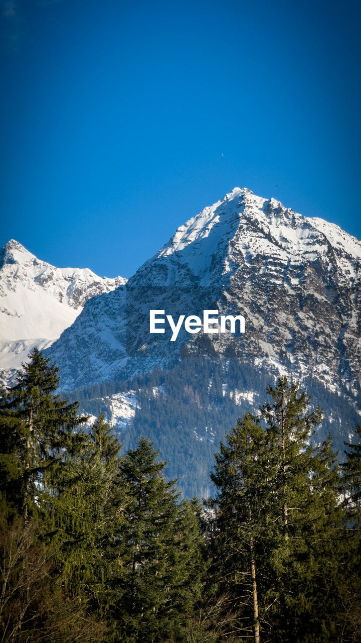Scenic view of snowcapped mountains against clear blue sky alps 