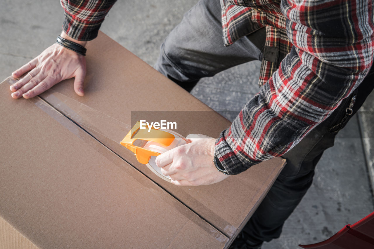 low section of man tying shoelace on table