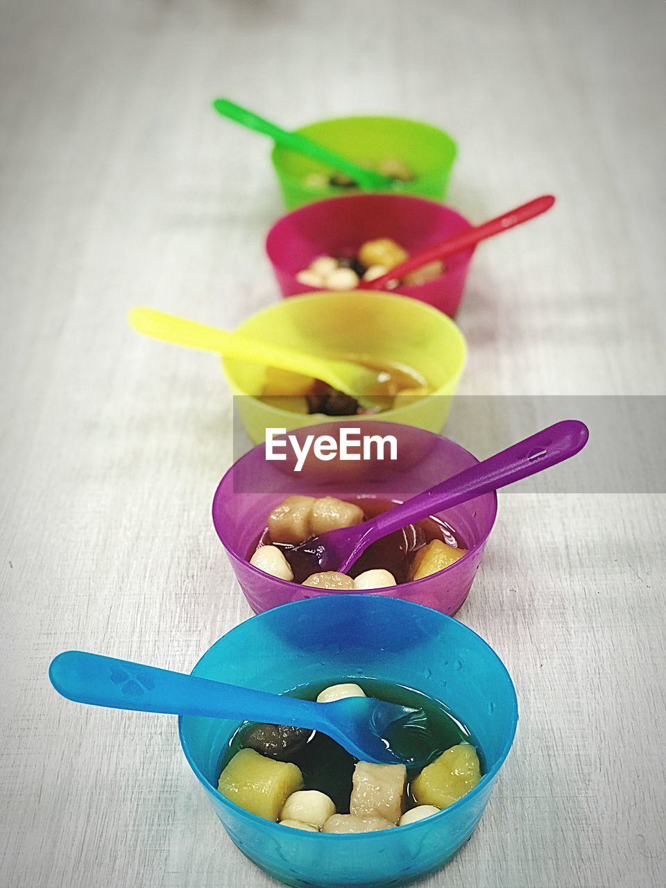 High angle view of multi colored bowls on table