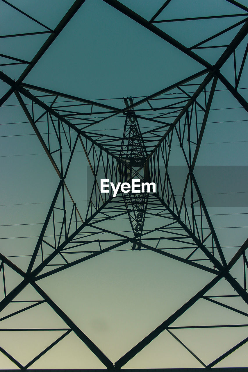 Low angle view of electricity pylon against sky