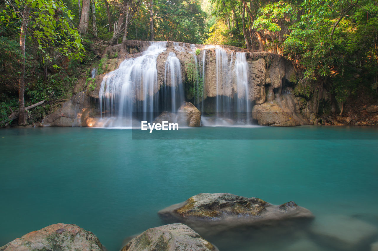 SCENIC VIEW OF WATERFALL IN ROCKS