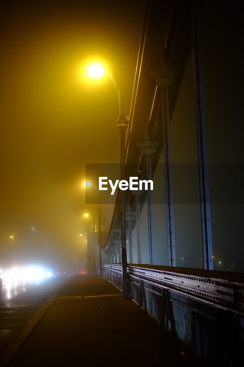 Illuminated bridge against sky at night