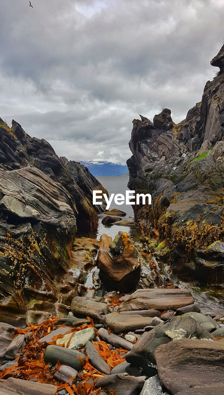 Rock formation amidst rocks against sky