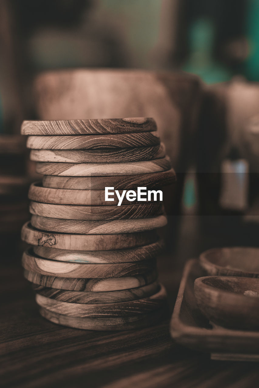 Stack of wooden plates on table