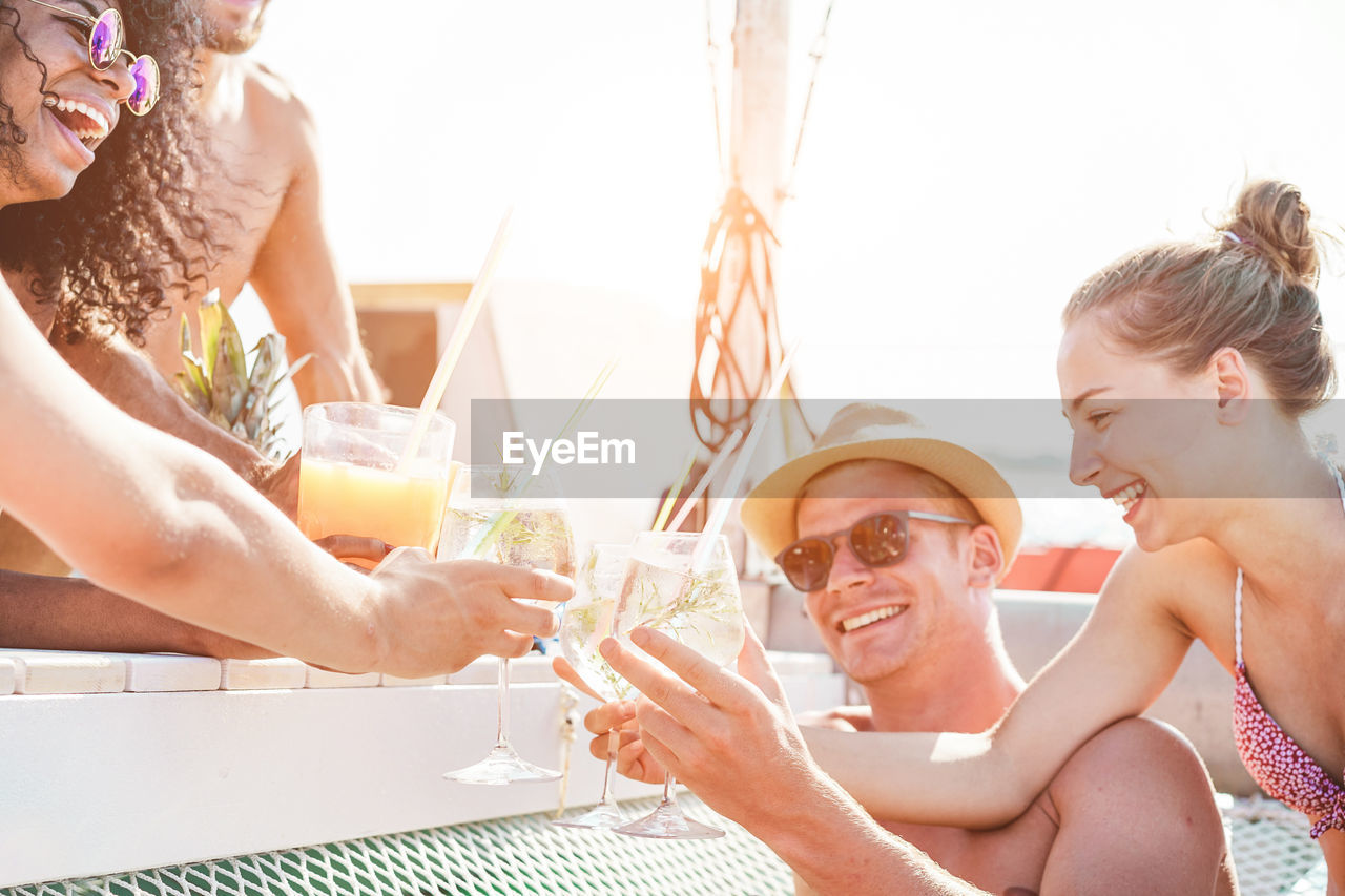 Cheerful friends partying in boat at sea