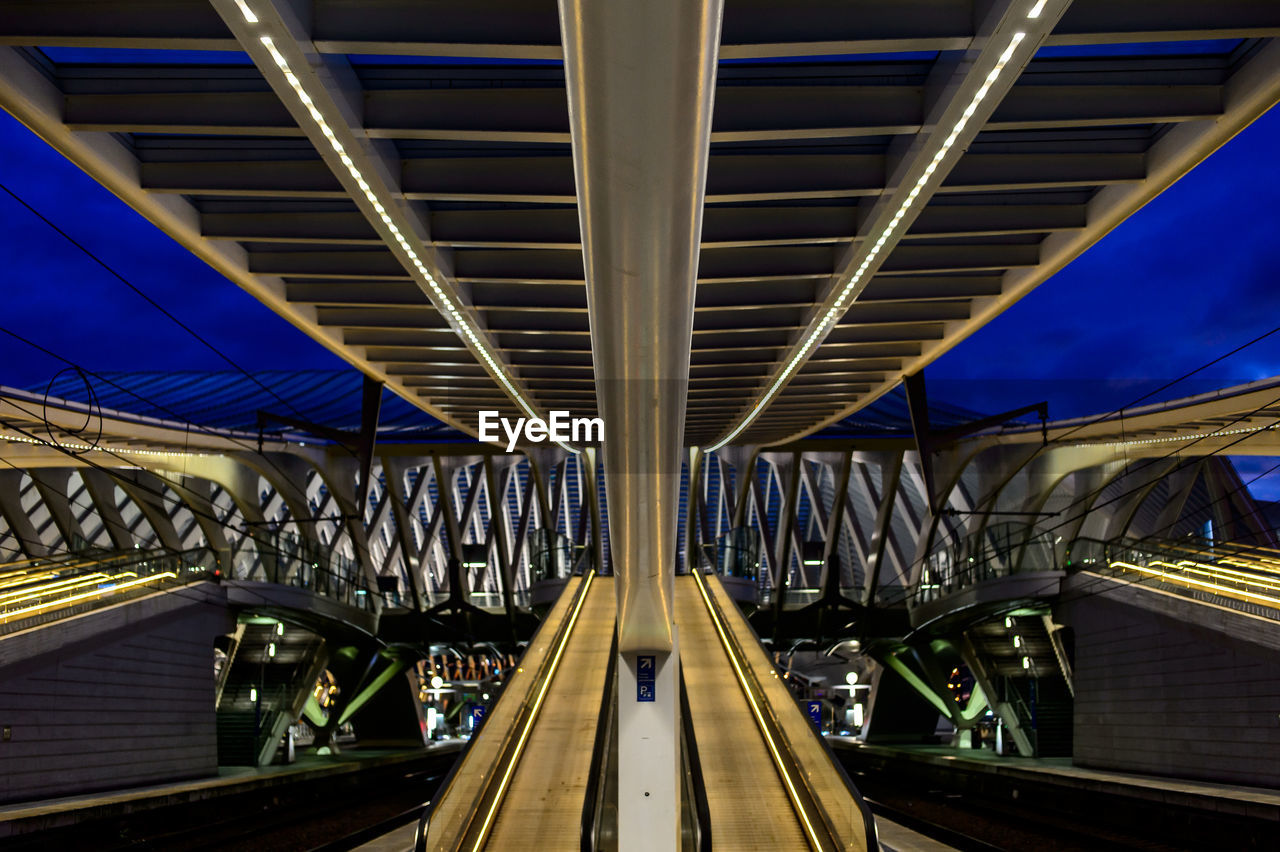 Illuminated bridge in city at night