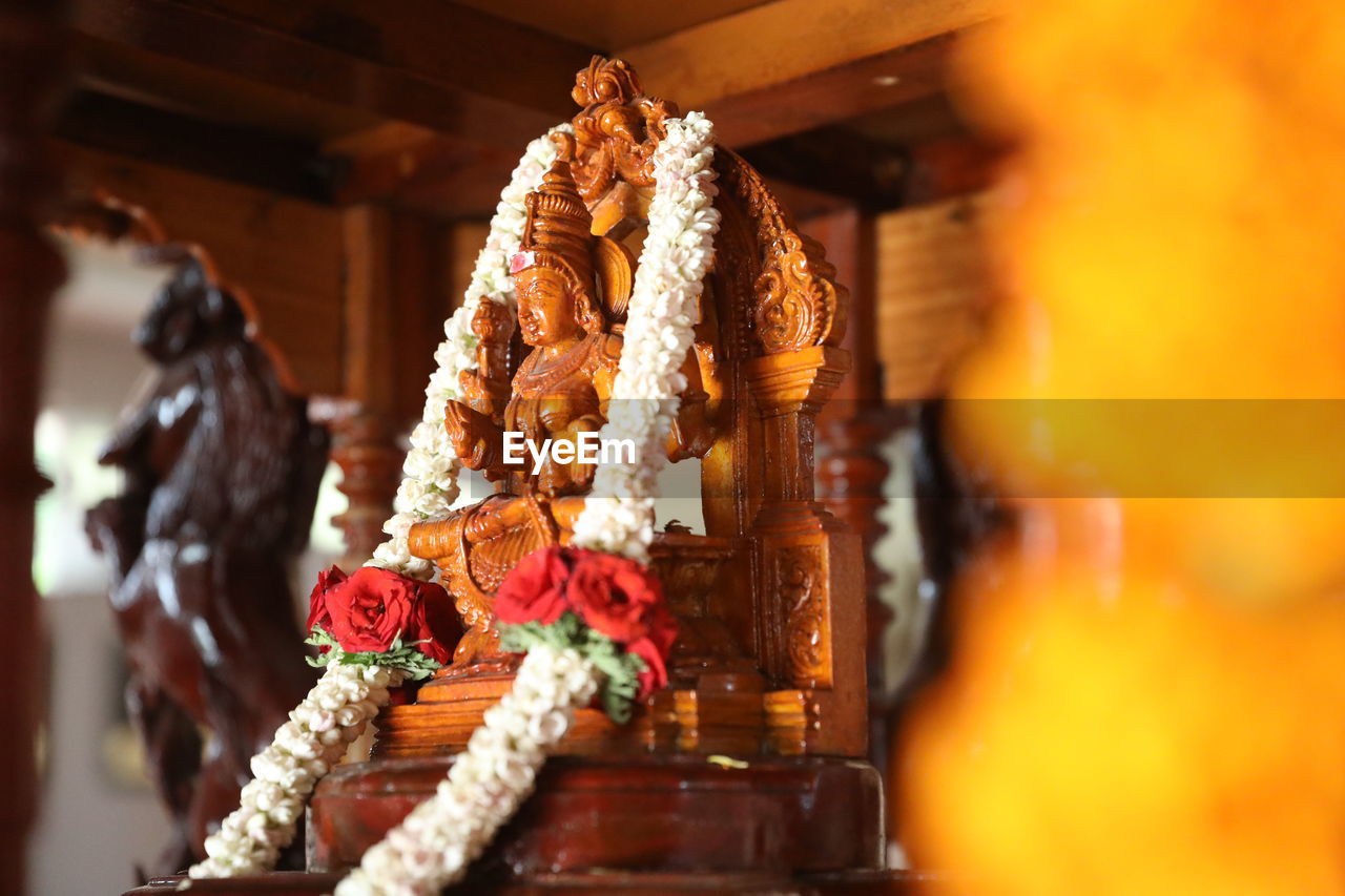 religion, belief, temple, spirituality, flower, no people, tradition, selective focus, celebration, indoors, yellow, temple - building, architecture, food and drink, craft, nature, decoration, holiday, food