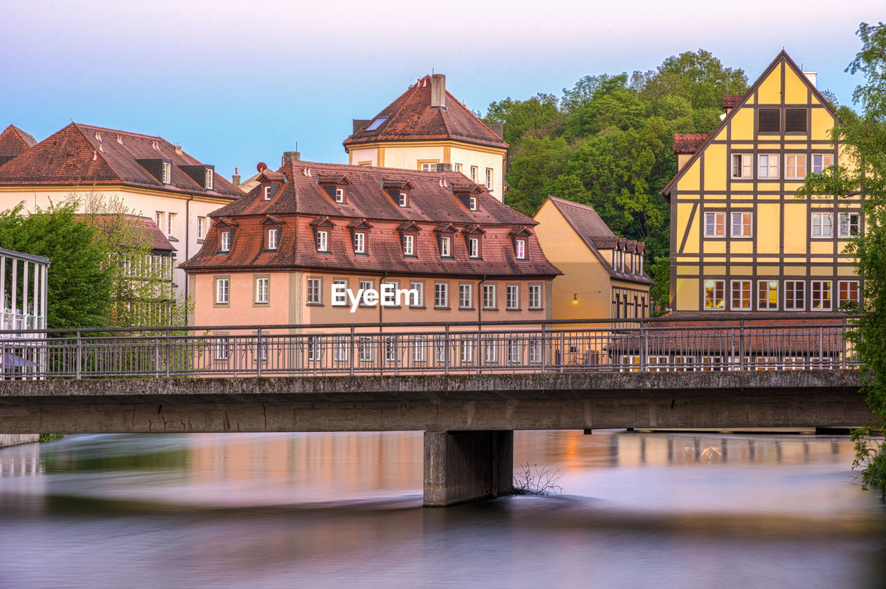 Bridge over river with buildings in background