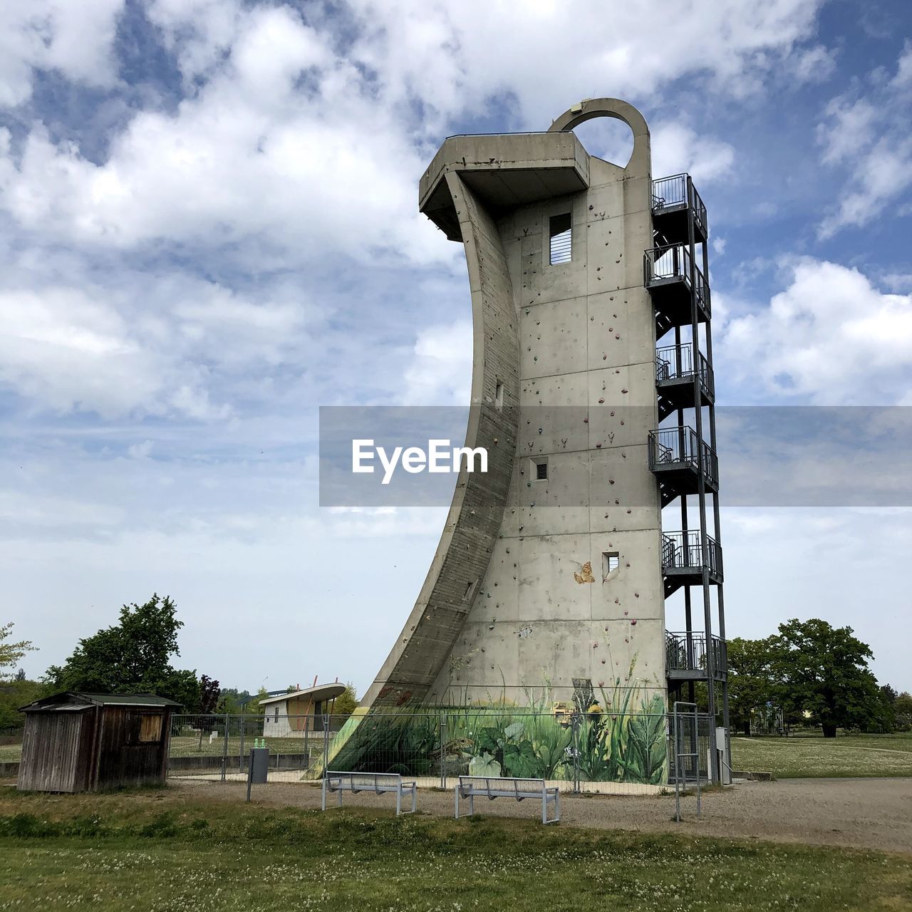 Low angle view of old tower on field against sky