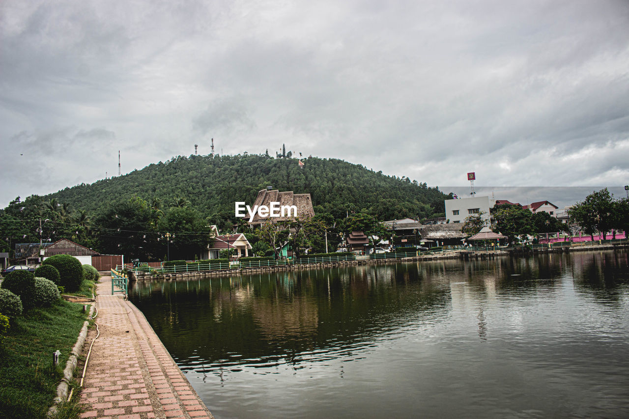 LAKE BY BUILDING AGAINST SKY