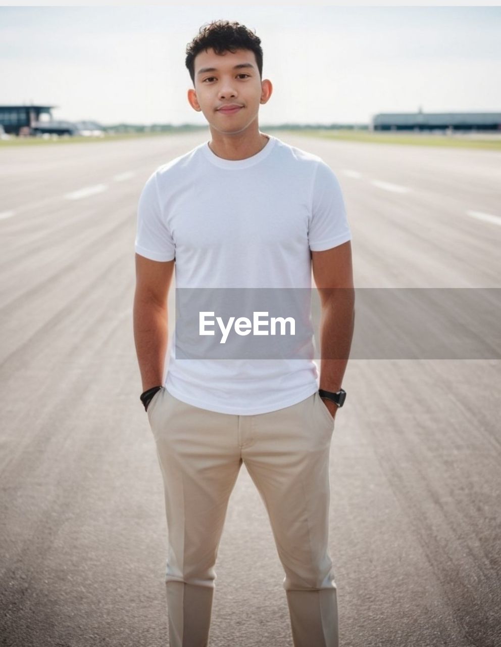 portrait of young man standing on road