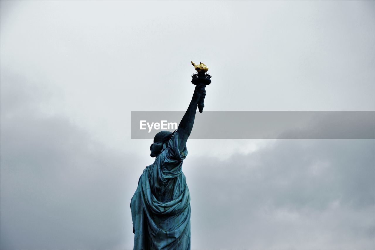 Low angle view of statue of liberty against sky