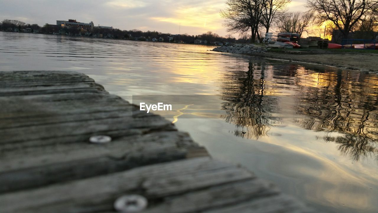 Pier over lake at sunset