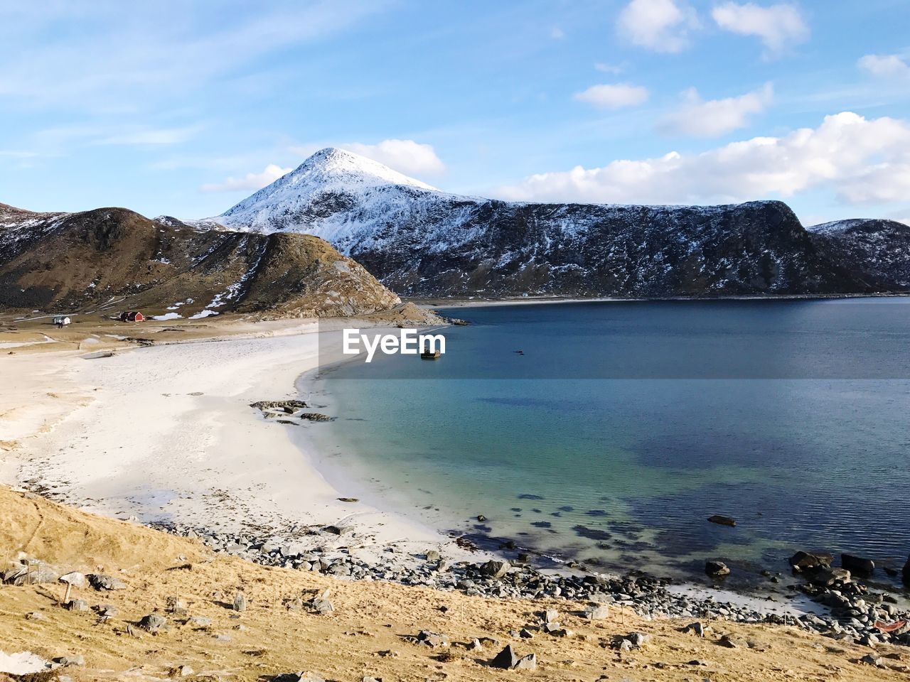 Scenic view of sea and mountains against sky