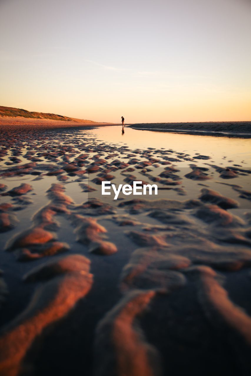 scenic view of sea against clear sky during sunset