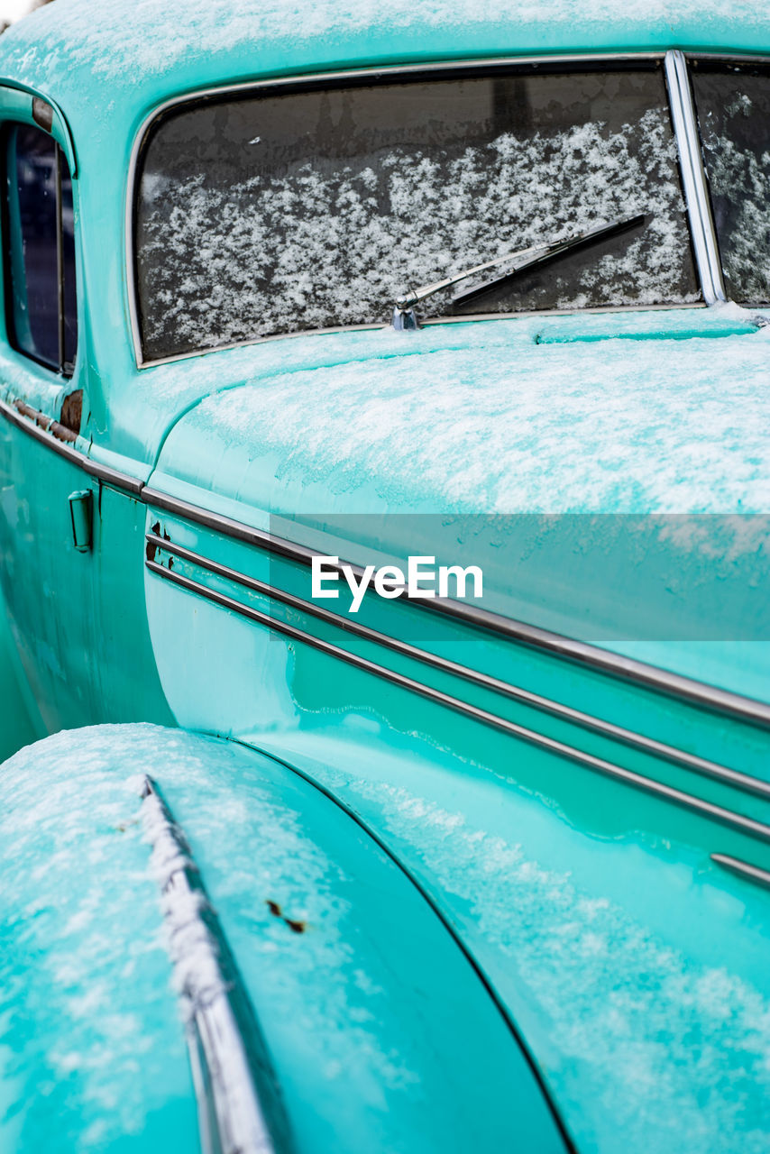 Full frame shot of blue car window with snow