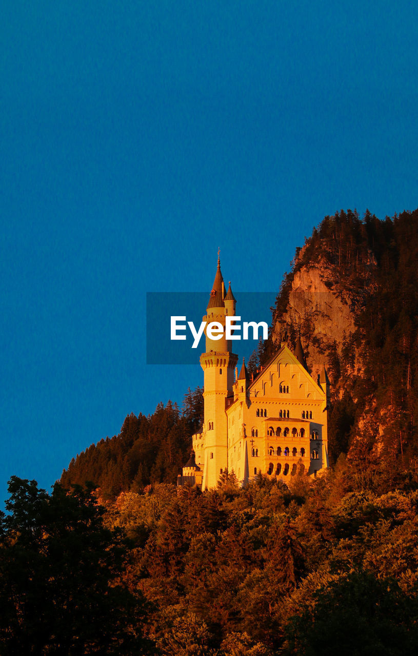 Low angle view of castle against clear blue sky