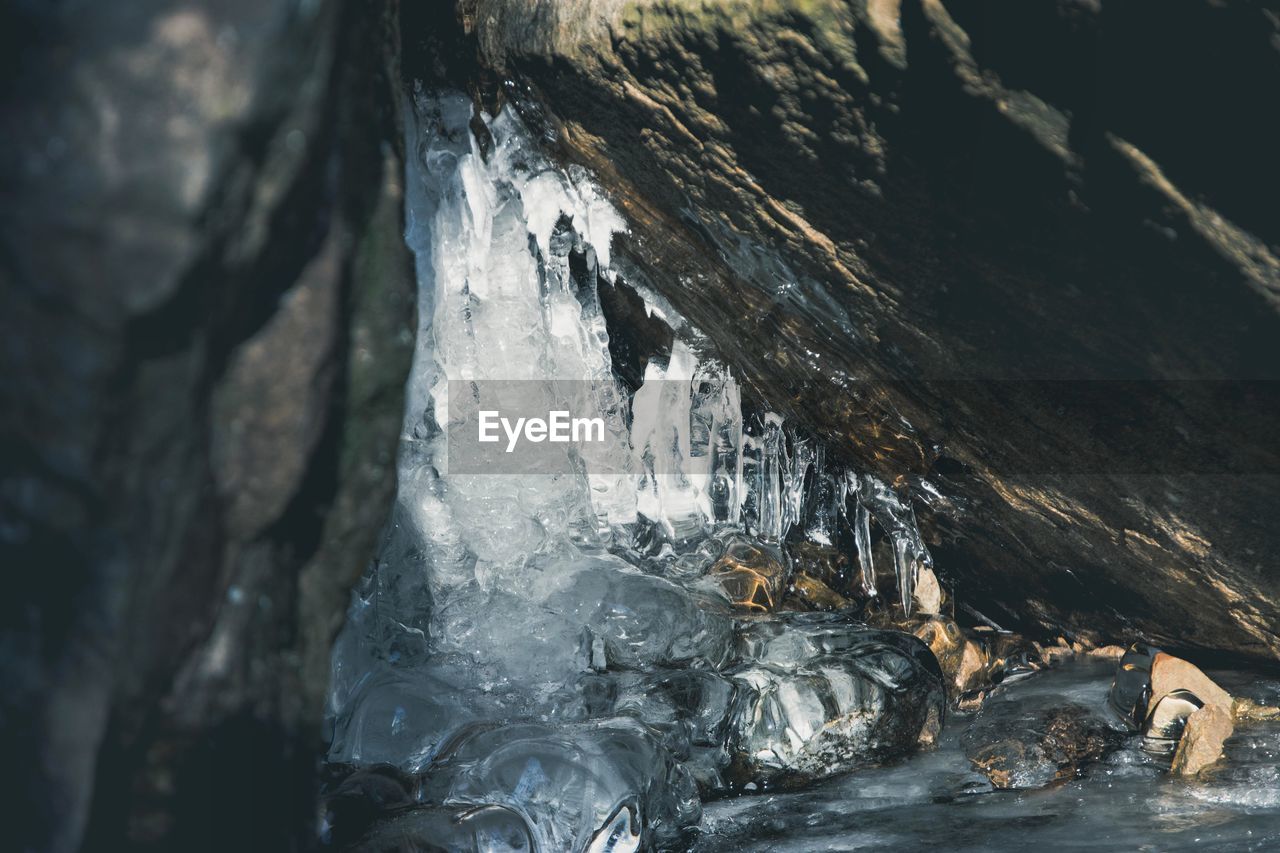 SCENIC VIEW OF FROZEN CAVE IN WINTER
