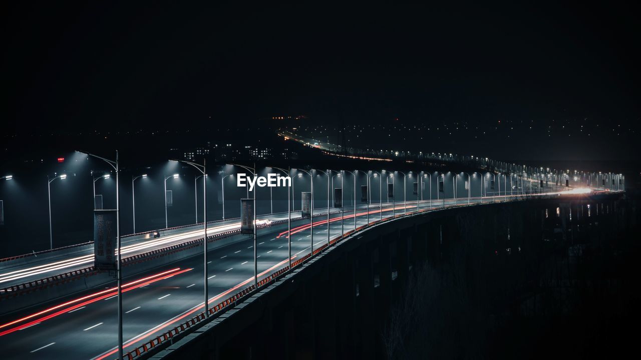 Illuminated bridge at night